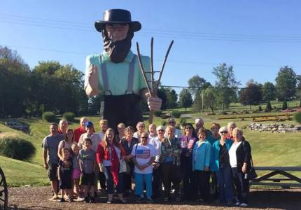 Pittsboro Baptist Church congregation standing outside in front of farmer statue
