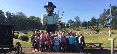 Pittsboro Baptist Church congregation standing outside in front of farmer statue